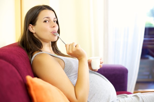 Pregnant woman eating a healthy snack