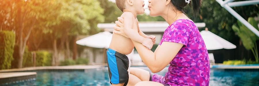 Mother and child by swimming pool