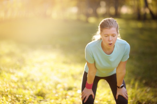 A woman stops exercising to catch her breath