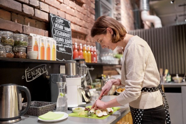 Woman cutting vegetables in kitchen