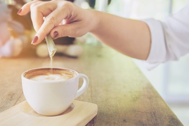 Sweetener being poured into coffee