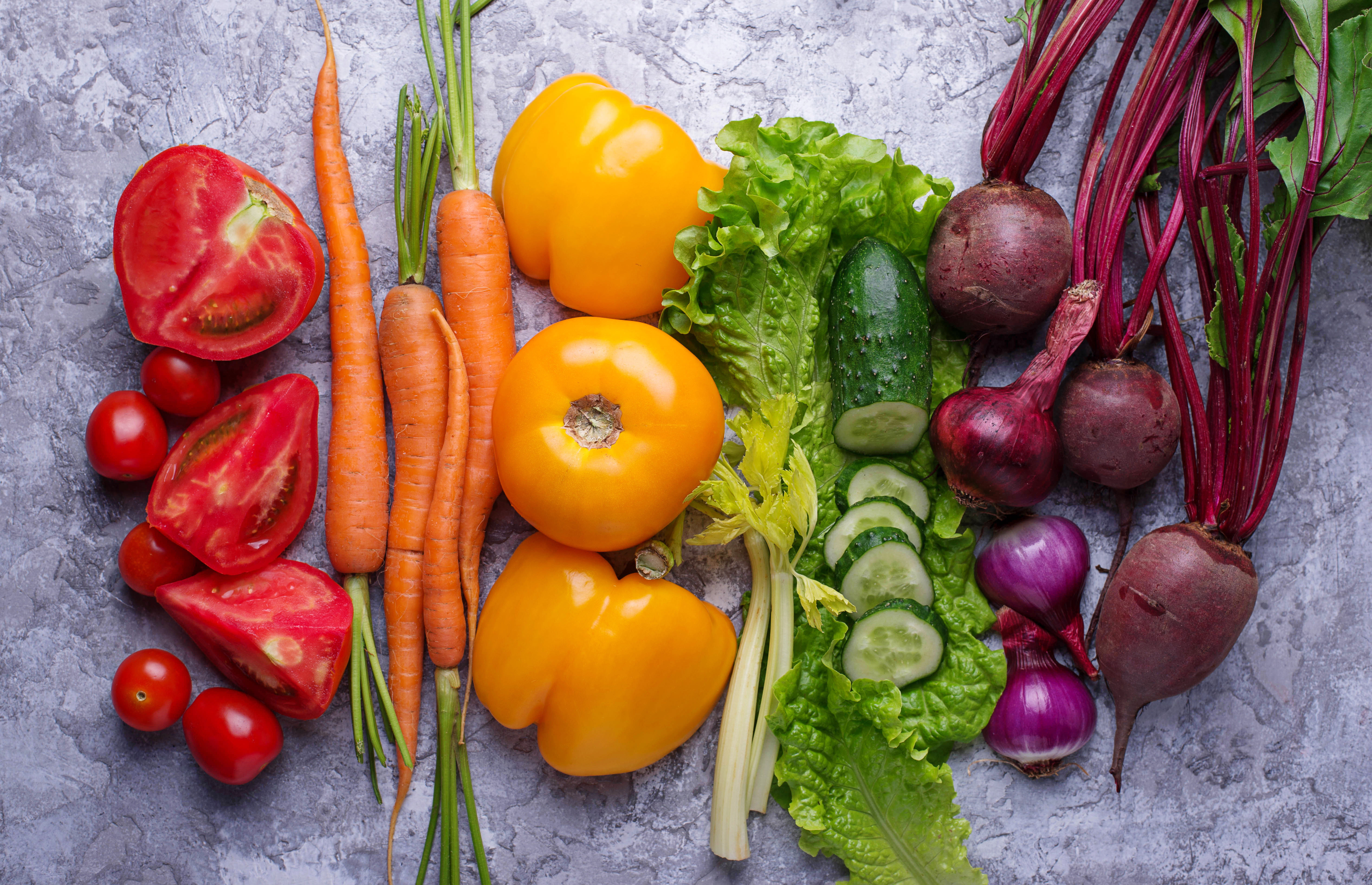 Fruits and veggies are arranged into a rainbow. 