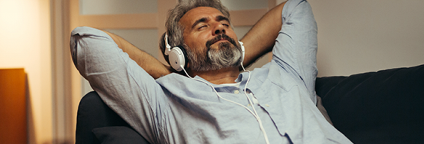 A man listens to calming music to ease anxiety, lower stress, and improve heart health
