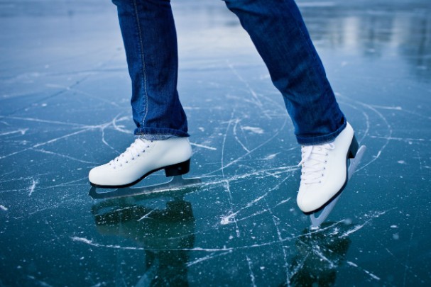 Person ice skating on a frozen pond