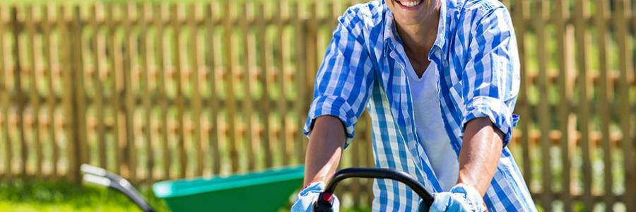 Person mowing lawn on hot summer day