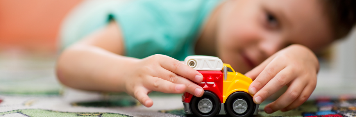 Young child plays with safe toys his parents gave him for Christmas