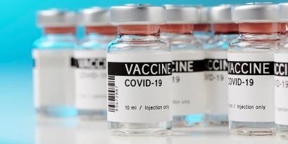Several doses of the COVID-19 vaccine sit on a counter.